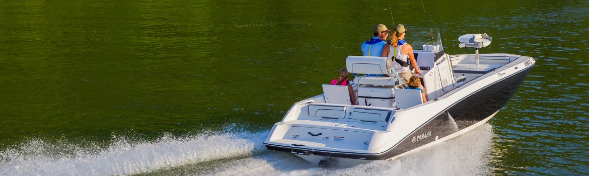 Family cruising down the water on a Yamaha boat on a sunny day